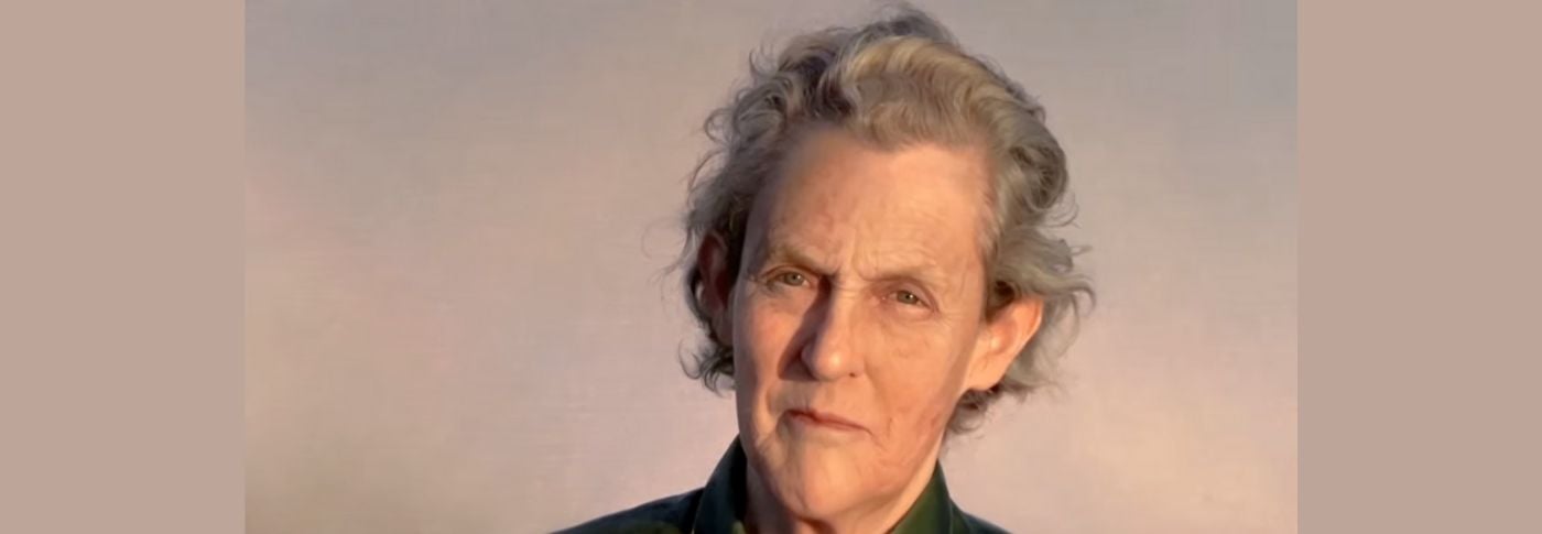 Temple Grandin, a world-renowned animal scientist and autism advocate, looks toward the camera in a close-up portrait against a softly lit background.
